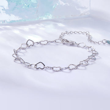 Silver chain bracelet on a light blue and white gradient background