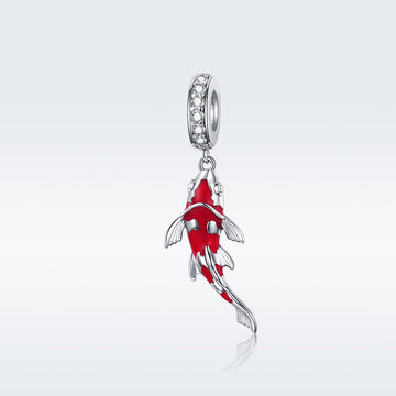 Red fish-shaped pendant with silver accents on a white background