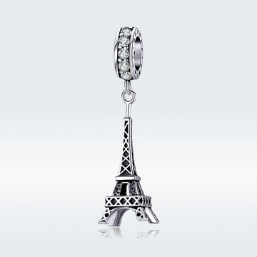 Silver Eiffel Tower charm with clear gemstones on a white background
