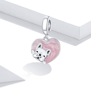 Silver charm with a pink heart and dog design on a white background