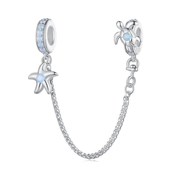 Silver charm with starfish and turtle design on a white background