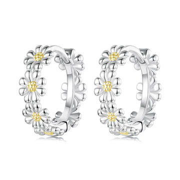 Pair of silver hoop earrings with floral designs on a white background