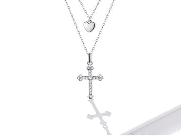 Silver necklace with heart and cross pendants on a white background