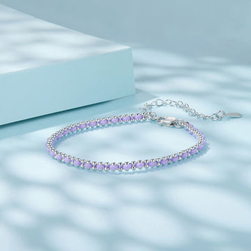 Silver bracelet with purple beads on a light blue background