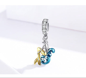 Jewelry charm with gold and blue design on a white background