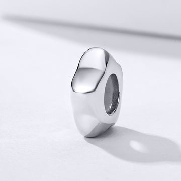 Silver ring on a light gray background