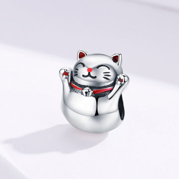 Silver cat-shaped charm on a light gray background