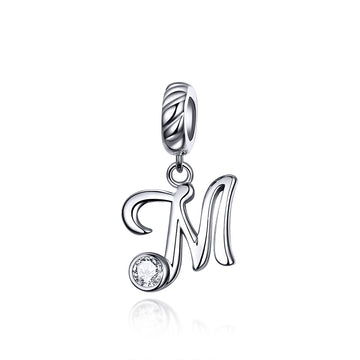Silver pendant with letter 'M' and clear gemstone on a white background
