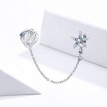Silver earrings with starfish and shell design on a white background