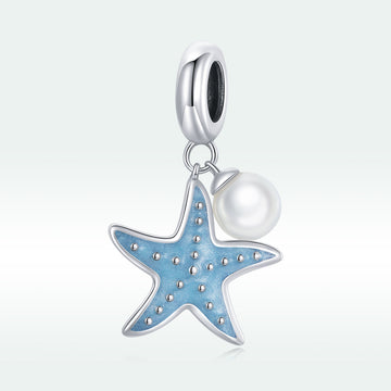 Starfish and pearl charm on a white background
