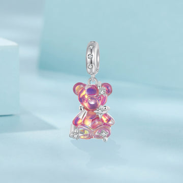 Pink teddy bear charm on a light blue background