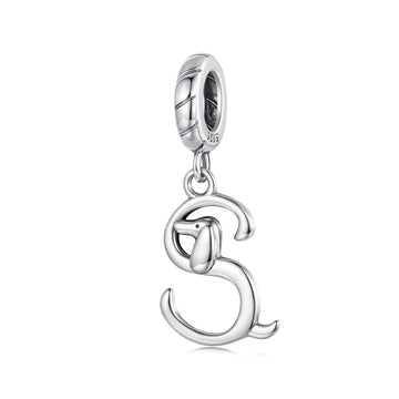 Silver dog charm on a white background