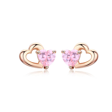 Heart-shaped earrings with pink gemstones and rose gold frames on a white background