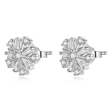 Pair of silver earrings with clear gemstones on a white background