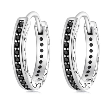 Pair of silver hoop earrings with black gemstones on a white background