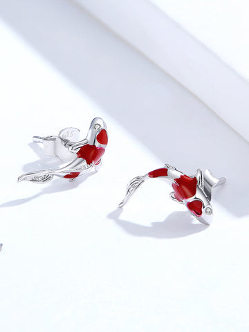 Pair of red and silver fish-shaped earrings on a white background