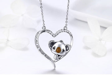 Silver necklace with a koala pendant on a white background