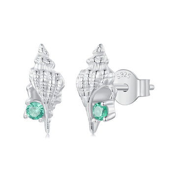 Silver shell earrings with green gemstones on a white background