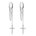 Silver hoop earrings with chain and cross pendants on a white background