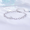 Silver chain bracelet on a light blue and white gradient background