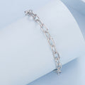 Silver chain bracelet on a light blue geometric background