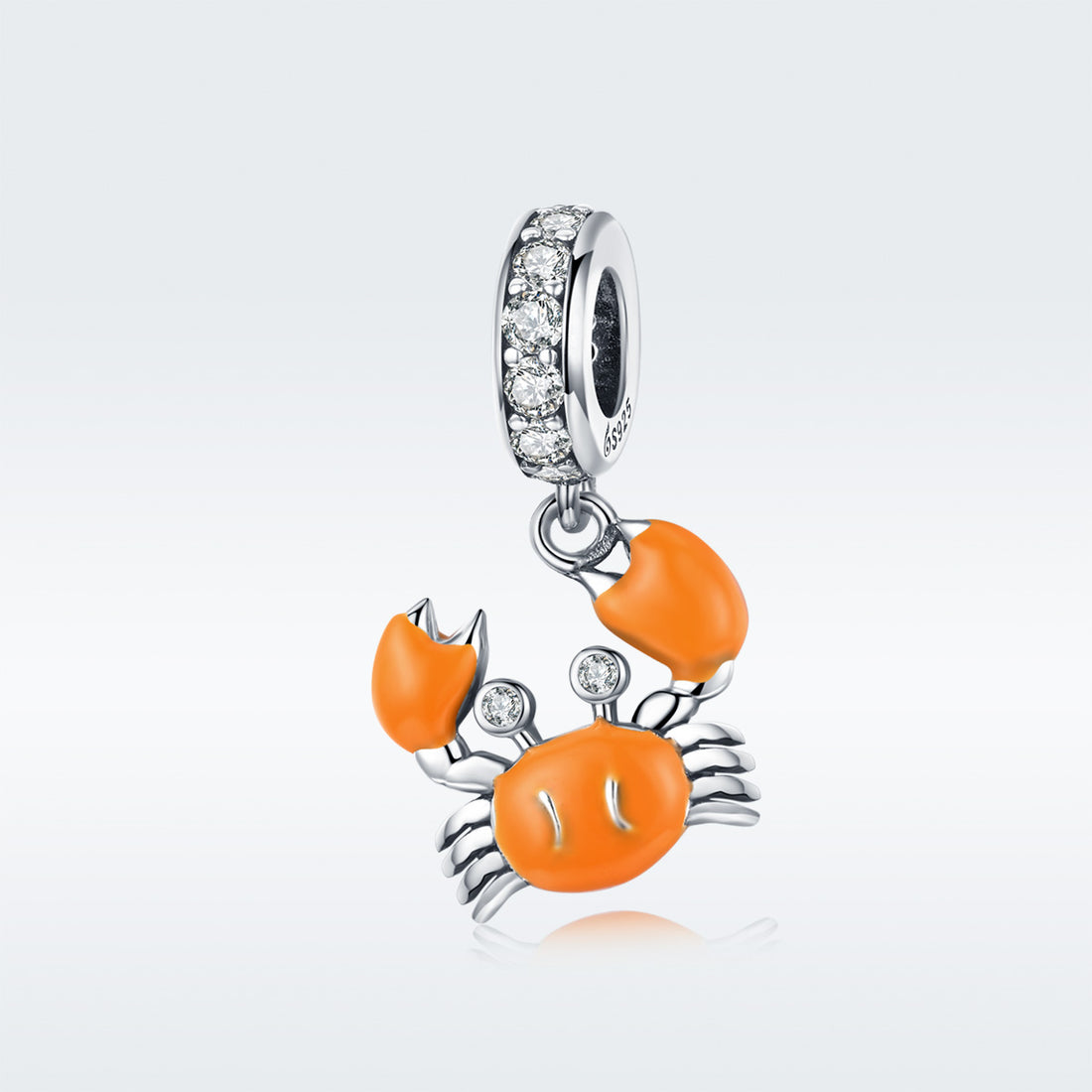 Silver charm with orange crab design on a white background