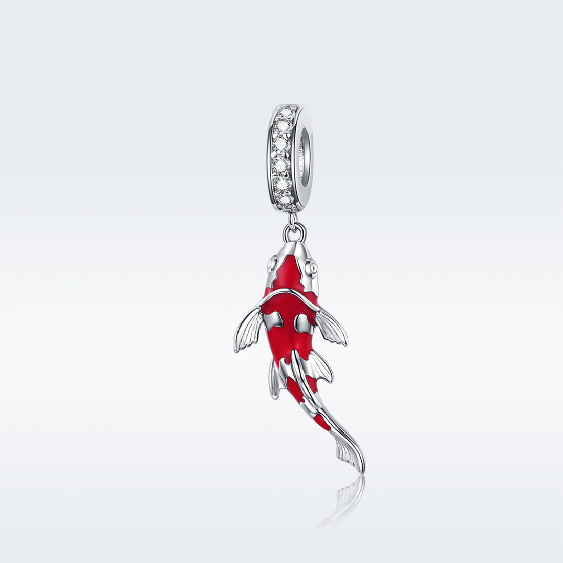 Red fish-shaped pendant with silver accents on a white background
