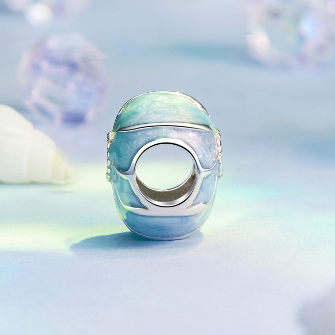 Decorative blue and silver object on a light blue background