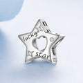 Silver star-shaped charm with 'lucky star' engraving on a light blue background