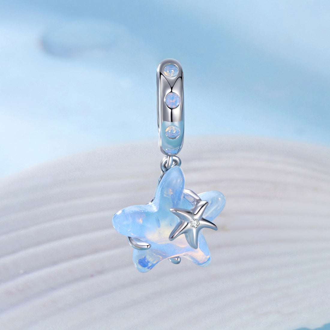 Blue starfish-shaped pendant on a light blue background