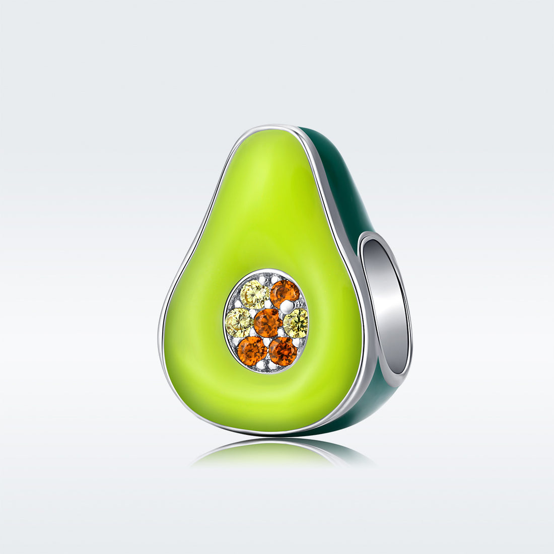 Avocado-shaped jewelry charm with gemstones on a light background