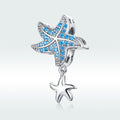 Starfish-shaped charm with blue gemstones on a light gray background