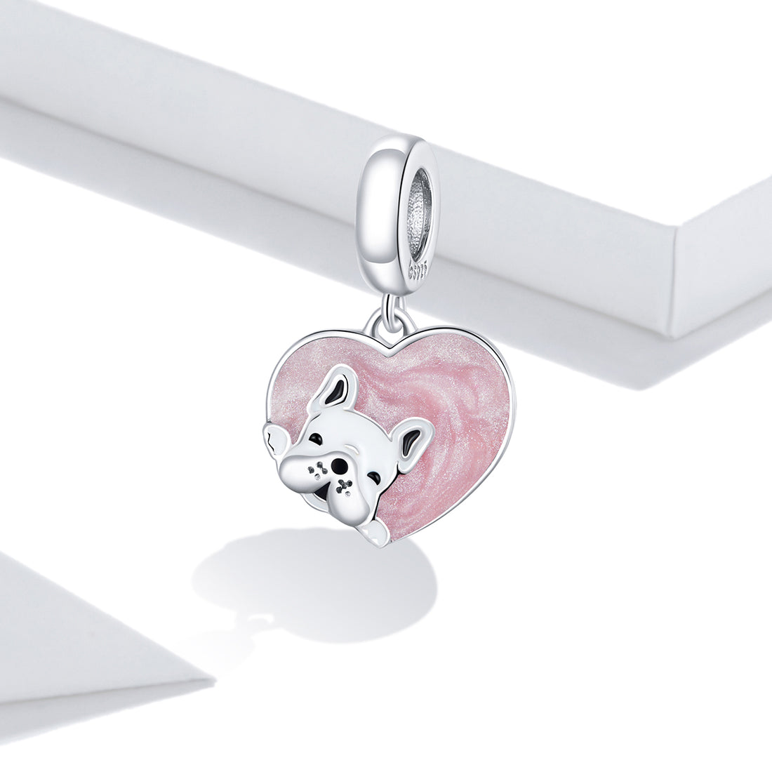Silver charm with a pink heart and dog design on a white background