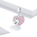 Silver charm with a pink heart and dog design on a white background