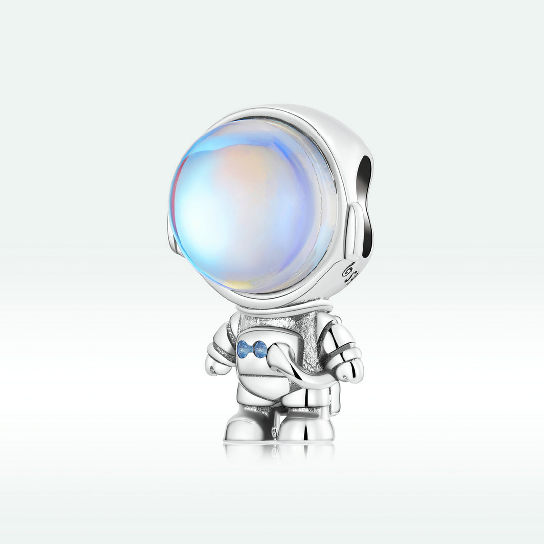 Silver charm with a colorful gem on a white background
