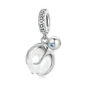Silver charm with a blue gemstone on a white background