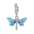 Blue butterfly charm with clear gemstones on a white background