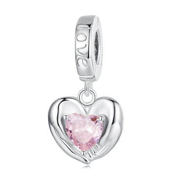 Silver heart-shaped charm with a pink gemstone on a white background
