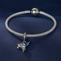 Silver bracelet with a charm on a dark blue background
