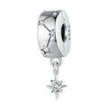Silver charm with star design on a white background