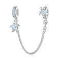 Silver charm with starfish and turtle design on a white background