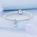 Silver bracelet with heart-shaped charm on a light blue background
