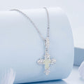 Silver cross necklace on a light blue background