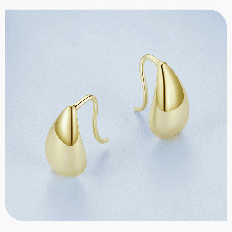 Gold teardrop earrings on a white background