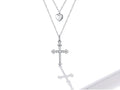 Silver necklace with heart and cross pendants on a white background