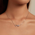 Necklace with a heart-shaped pendant on a person's neck