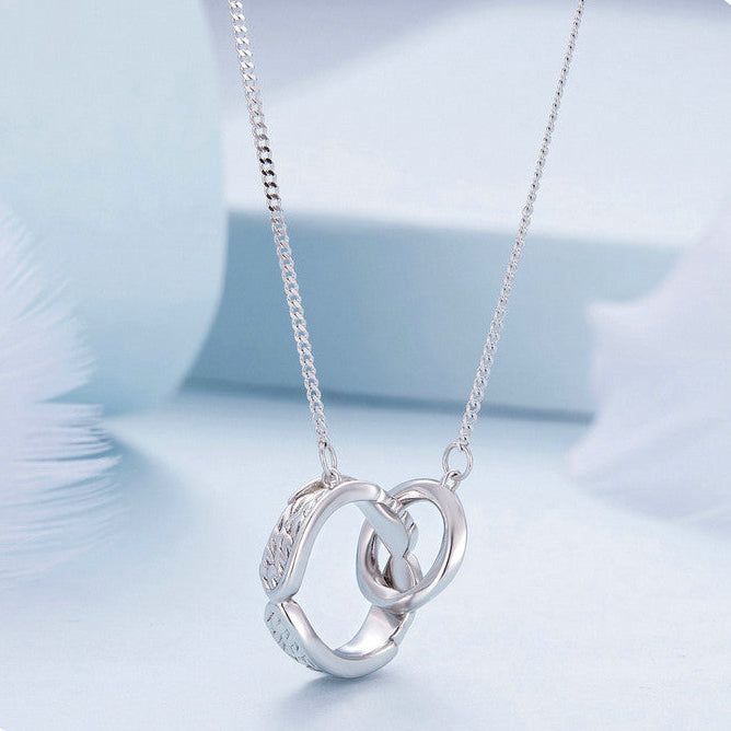 Silver necklace with interlocking rings on a light blue background