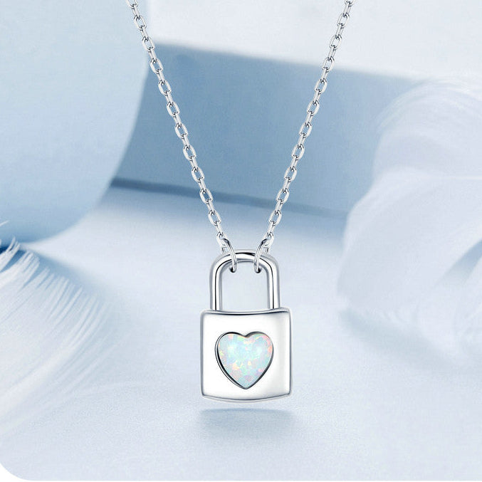 Silver necklace with a lock-shaped pendant on a light blue background