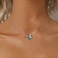 Necklace with a butterfly pendant on a person's neck, with text about jewelry quality.
