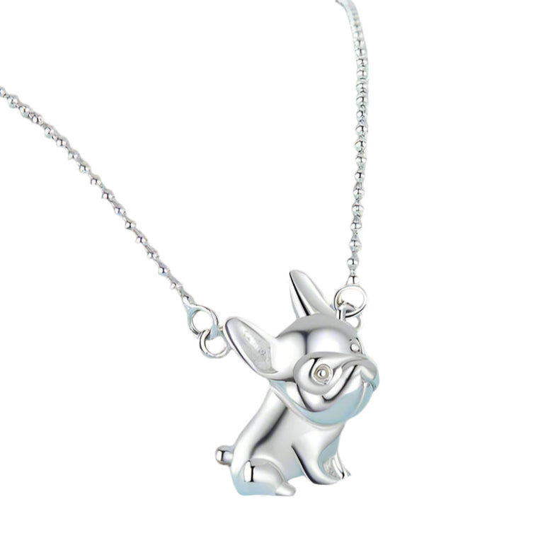 Silver dog-shaped pendant on a chain against a white background